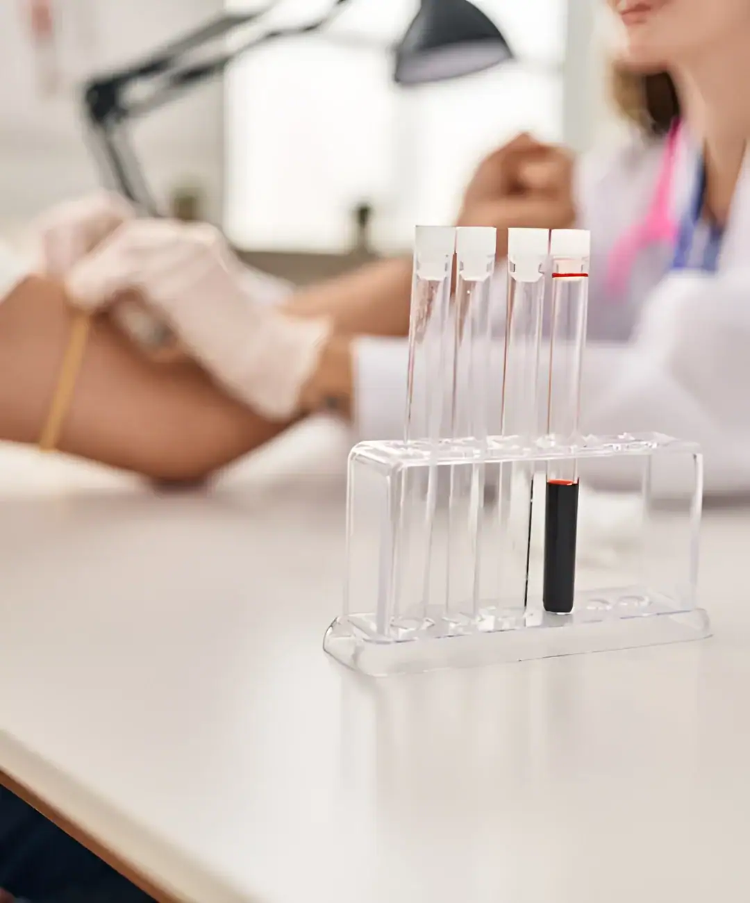 Test tube with red cap and black indicator in a laboratory setting.