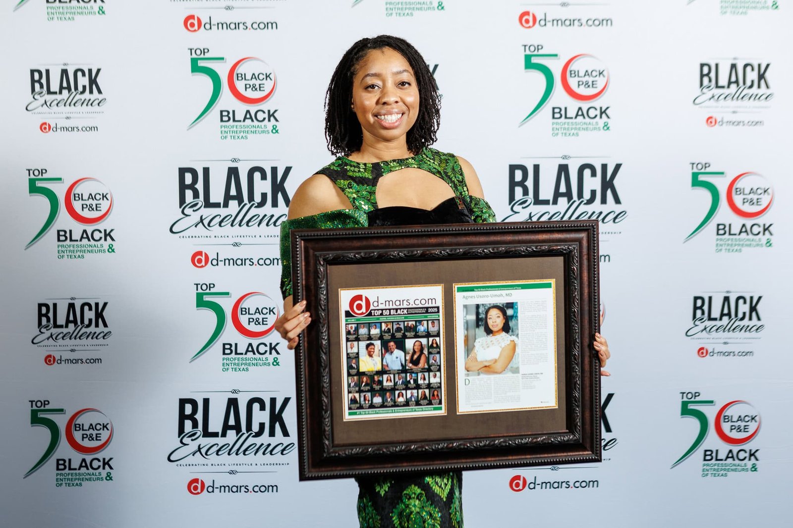 Woman holding a framed collage and portrait at the "In the Media" event.